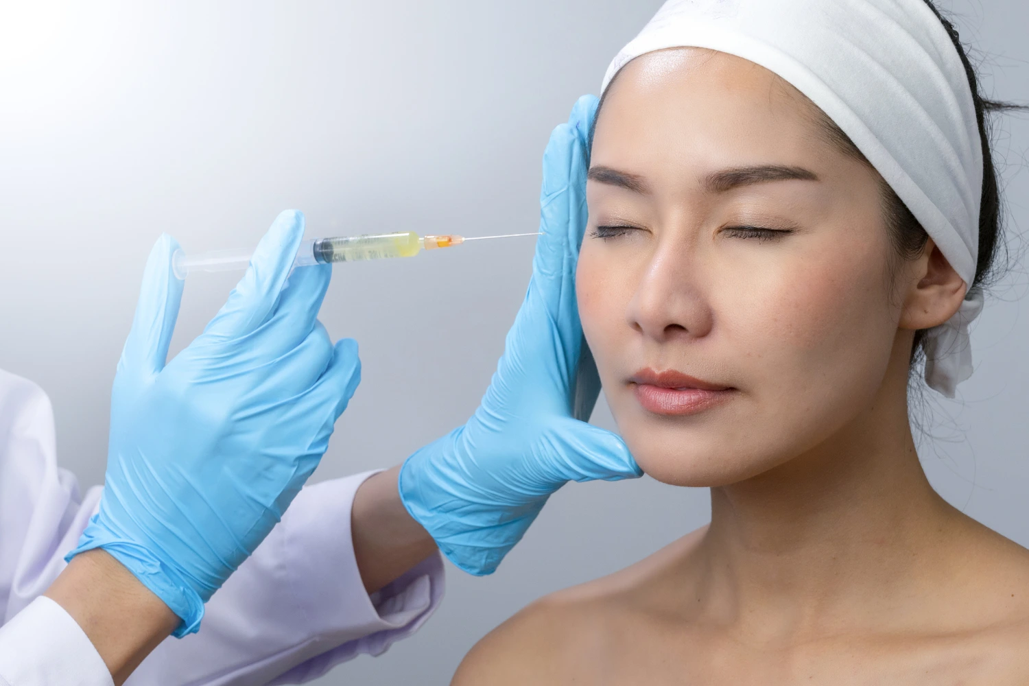 Lady undergoing Botulinum Toxin treatment at clinic.